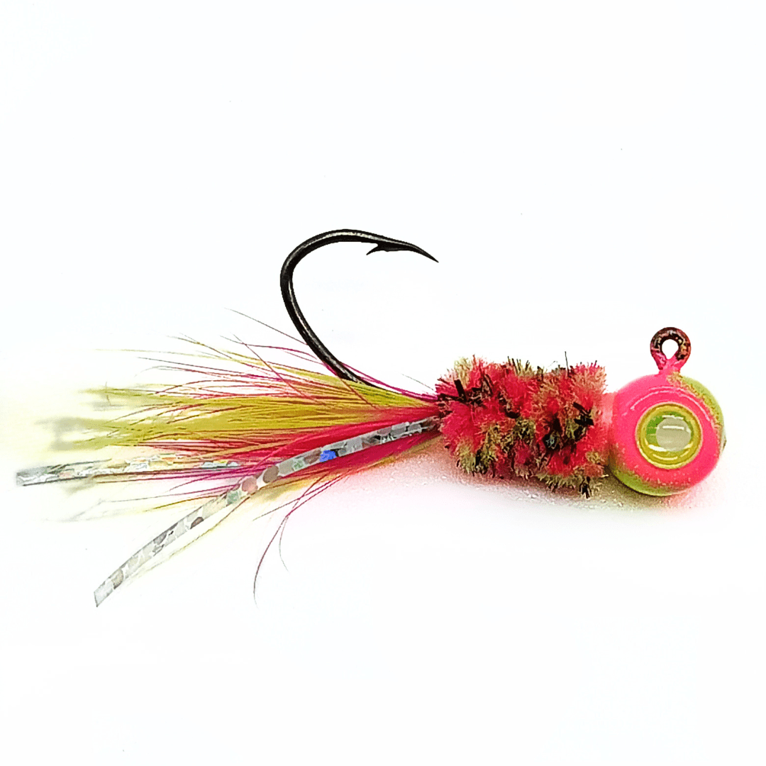 Hand tied crappie jig with a multi-colored feather tail, including yellow and pink feathers, and silver tinsel strands. The body is bright pink with green accents made of synthetic material, and the jig head is round and neon pink with a green eye. This crappie lure features a sickle hook, designed to attract fish by mimicking the appearance and movement of prey in the water, making it an effective and visually appealing bait for crappie fishing. This fishing lure is hand tied by Ramble Tamble Tackle.