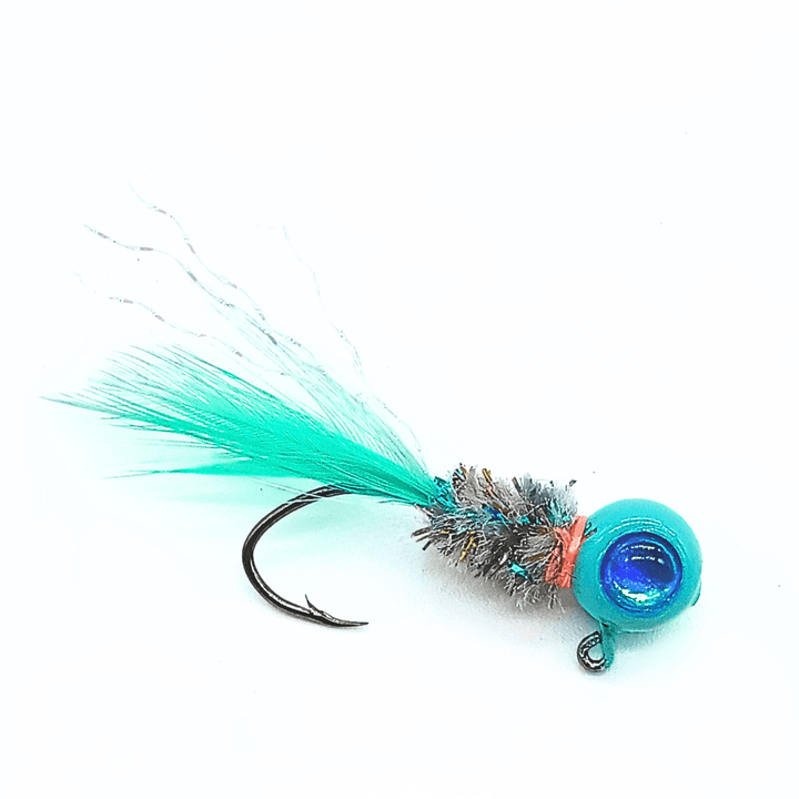 Hand tied crappie jig with a turquoise feather tail, a sparkly silver and blue body made of synthetic material, and a round turquoise jig head with a blue reflective eye. This crappie lure features a sickle hook, designed to attract fish by mimicking the appearance and movement of prey in the water, making it an effective and visually appealing bait for crappie fishing. This fishing lure is hand tied by Ramble Tamble Tackle.