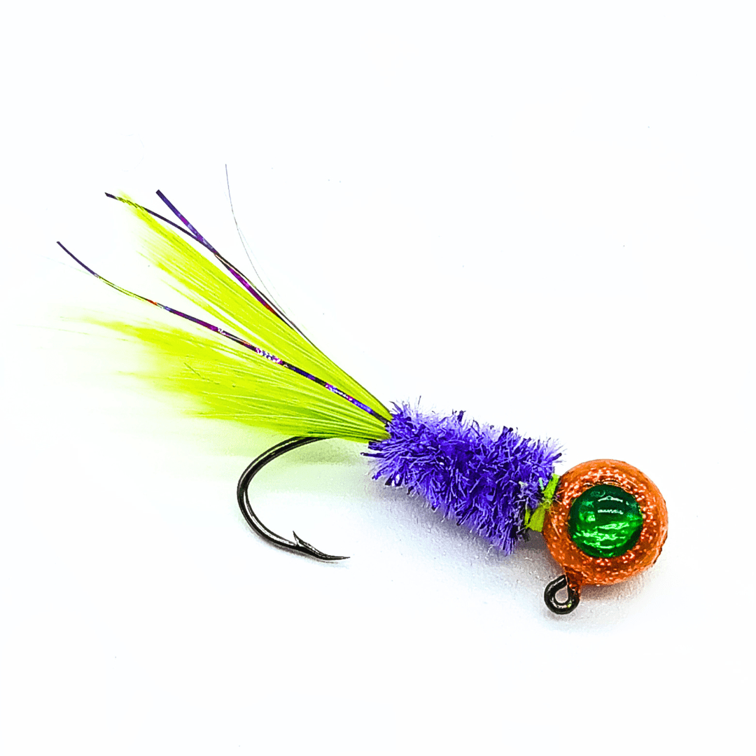 Hand tied crappie jig with a yellow and purple feather tail, a bright purple sparkly body made of synthetic material, and an orange round jig head with a green eye. This crappie lure features a sickle hook, designed to attract fish by mimicking the appearance and movement of prey in the water, making it an effective and visually appealing bait for crappie fishing. This fishing lure is hand tied by Ramble Tamble Tackle.