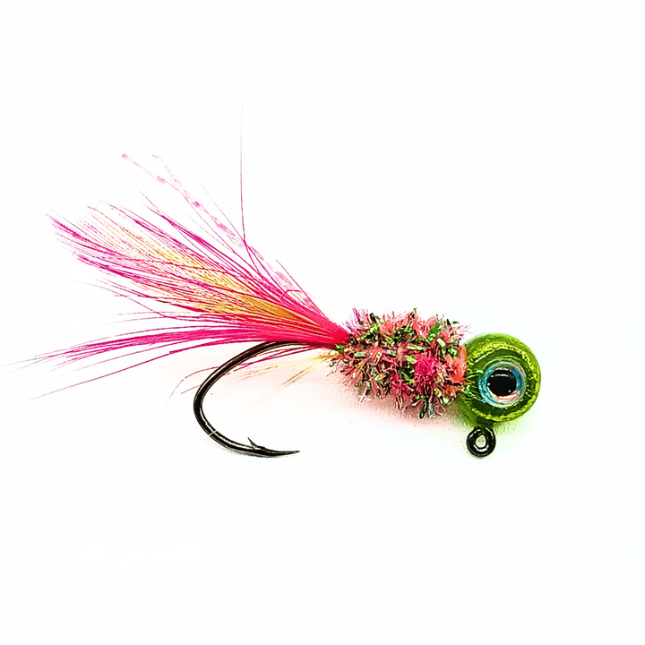 Hand tied crappie jig with a green head featuring an eye design, a body covered in pink and green material, and a tail made of pink and yellow feathers. This crappie lure features a sickle hook, designed to attract fish by mimicking the appearance and movement of prey in the water, making it an effective and visually appealing bait for crappie fishing. This fishing lure is hand tied by Ramble Tamble Tackle.