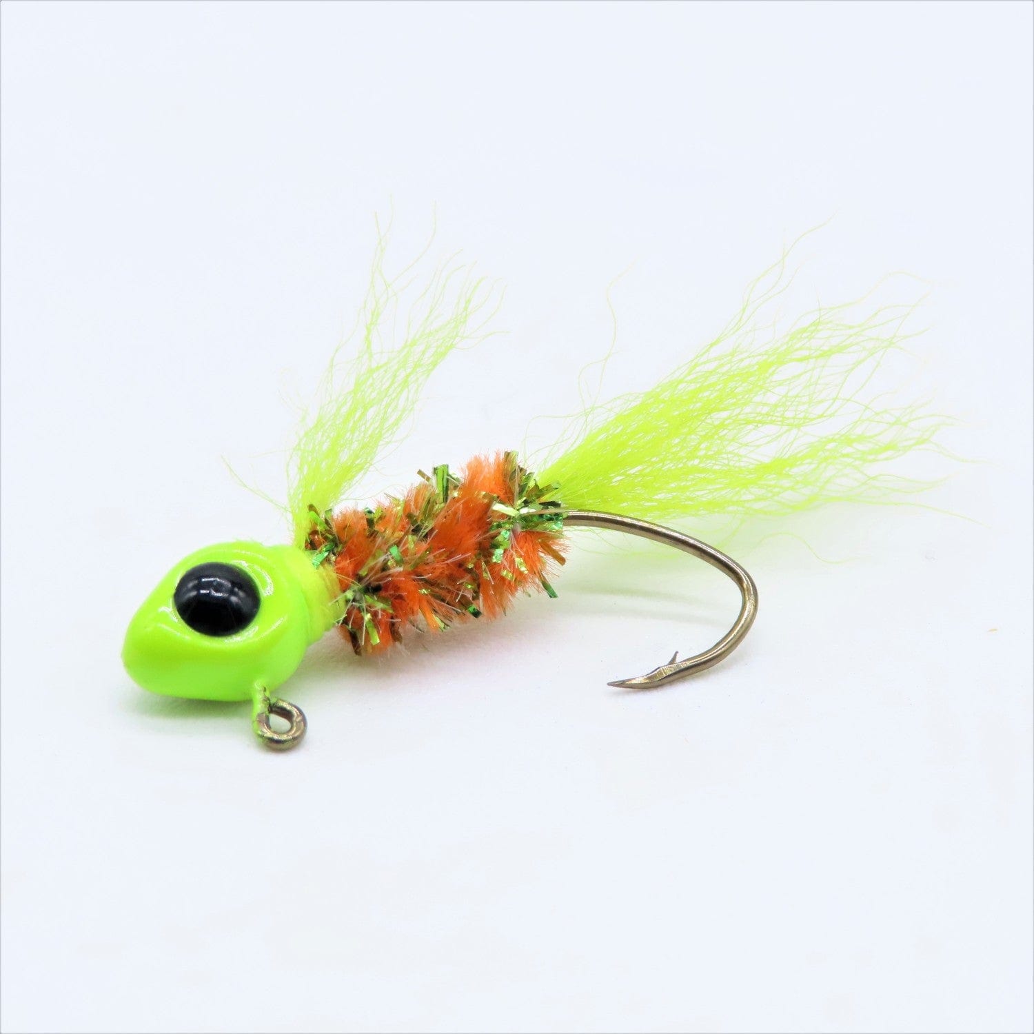 Hand tied crappie jig with a chartreuse feather tail, an orange and green sparkly body made of synthetic material, and a round chartreuse jig head with a black eye. This crappie lure features a sickle hook, designed to attract fish by mimicking the appearance and movement of prey in the water, making it an effective and visually appealing bait for crappie fishing. This fishing lure is hand tied by Ramble Tamble Tackle.